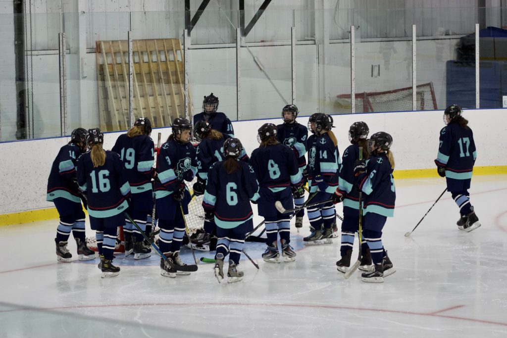 Fundy Kraken players celebrating on the ice